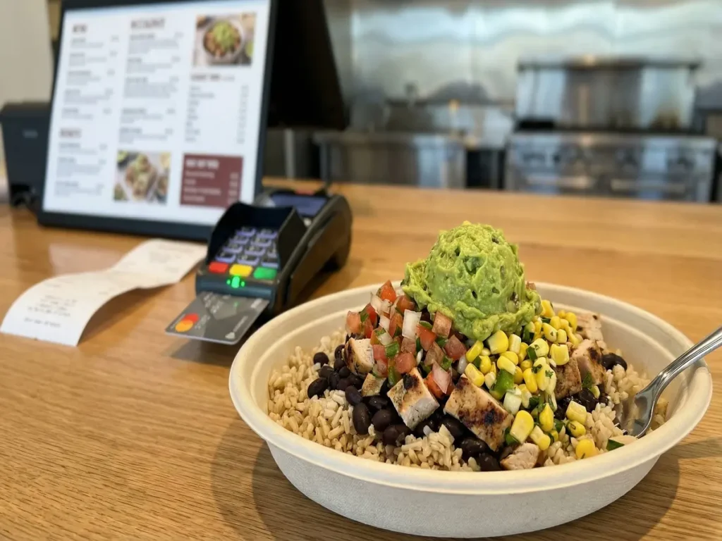 Chipotle style bowl near a checkout counter to represent bowl prices in the USA
